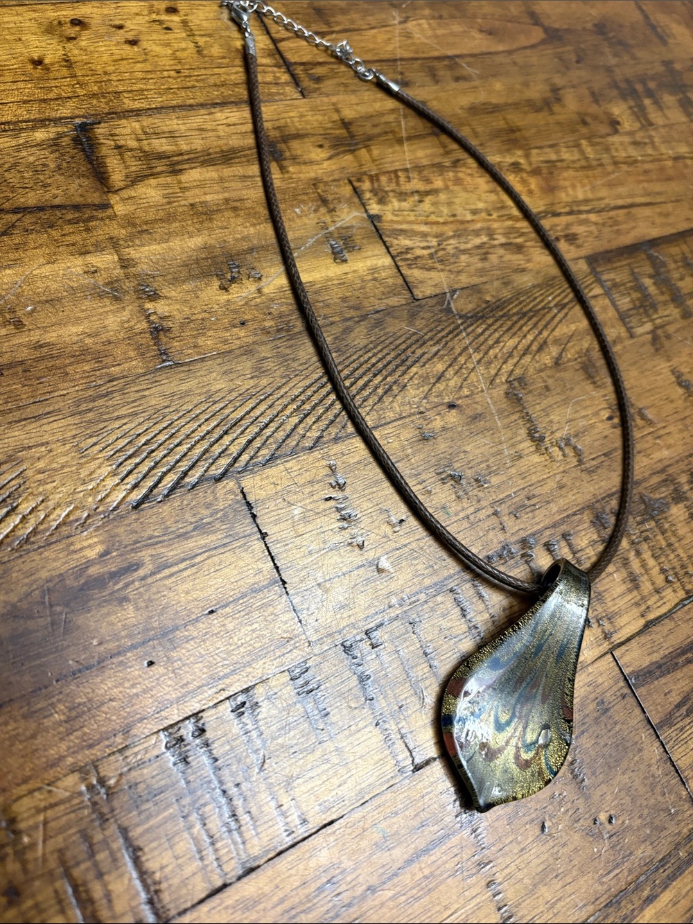 Murano type teardrop pendant in jewel tones with brown silk necklace.